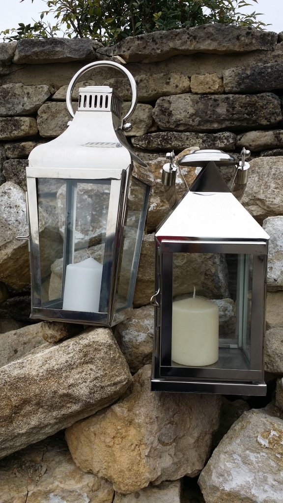 Two Large silver lanterns resting on Cotswold stones for weddings