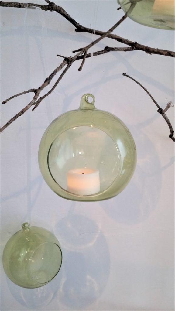 clear or green glass baubles or glass globes with tea lights to hire for woodland winter or summer wedding