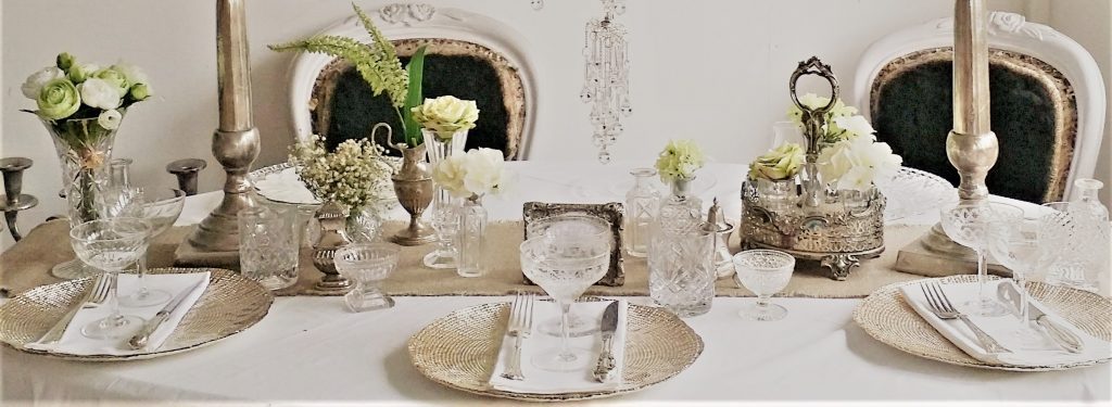 Cut crystal vintage glasses and champagne saucers, gold charger plates and silver candelabras with vintage vases and cruets for classical elegant weddings